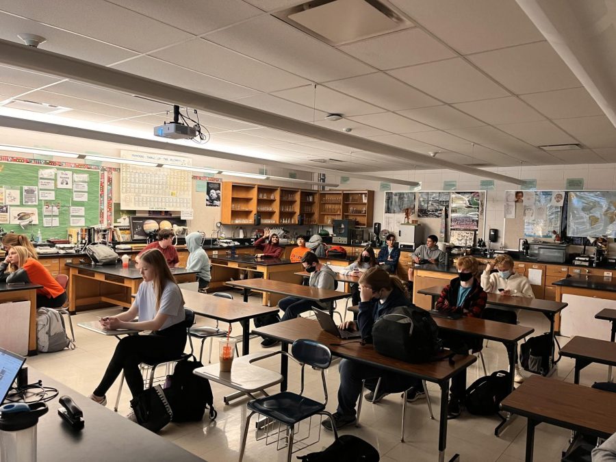 Students relaxing at the end of an ICB II class. In many STEM classes at East, including math, chemistry, biology, physics, woods, autos, PLTW, and  other courses, boys outnumber girls. Photo by Sophia Smallwood. 