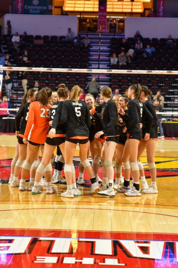 East%E2%80%99s+Girls+Volleyball+Team+exits+a+huddle+during+a+State+Finals+match+in+Bloomington.+Photo+courtesy+of+%0AKate+Goudreau.