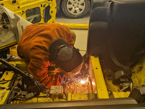Salvador Gomez welds the floor panels of a 1995 Ford Mustang at Auto Club’s meeting on Jan. 31. Photo by Nia Cocroft