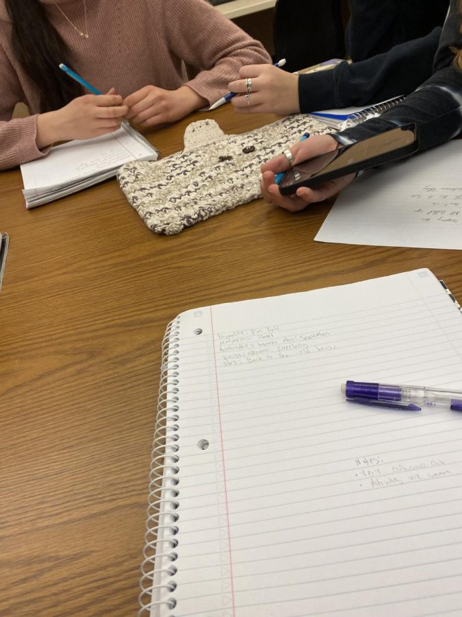 Ava Schroder, Maddie Barnes and Gwen Straiton participate in an activity where students shuffled their playlist of music and wrote a story with the song that showed up.  