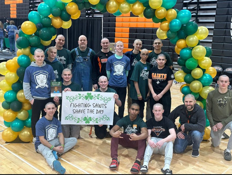 The East teachers and students who helped raise money for the popular fundraiser for cancer pose after their shave.
Photo courtesy of the St. Charles East High School website