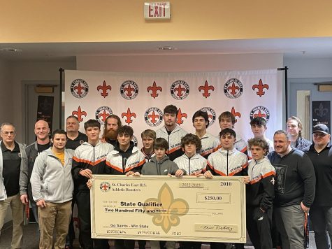 The Wrestling Team is recognized at a traditional East “Send-off Ceremony” along with a contribution from the St. Charles East’s Athletic Boosters. From left to right: (coaches)
Mick Reuttiger, Jason Potter (Head Coach), Anthony Rubino, Joel Crawford, Chris
Potter, Max Payleitner, Joe Barczak, and John Robinson; (athletes) Lane Robinson (Sr.), Tyler Guerra(Jr.), Ethan Penzato(Sr.), Domenic Munaretto (Fr.), Austin Barrett(Sr.),
Ben Davino(Jr.), Anthony Gutierrez(So.), Jayden Colon(Jr.), Brandon Swartz(Jr.), Brody Murray(Jr.), AJ Marino(Sr.) Photo by Evan Lagana