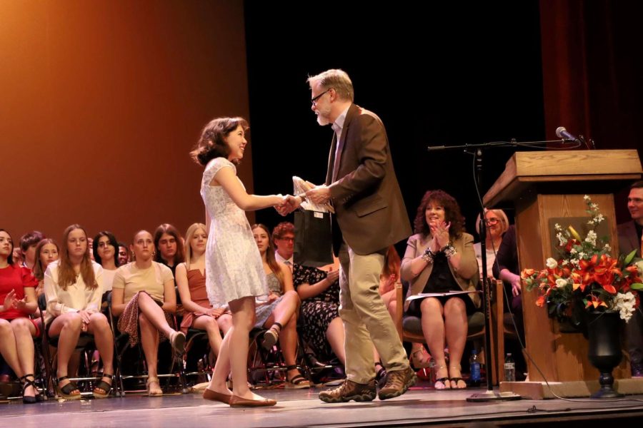 At Honors Night, Senior Rachel Cornille is recognized by English teacher Mr. Courtenay Burkhart for being the English Departments Senior Award recipient.