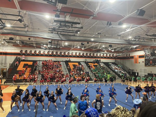 The dance and cheer teams open Small Games assembly accompanied by St. Charles East band. 