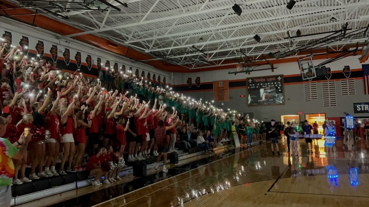 Students in the audience turn on their flashlights during the drumline showcase. Photo courtesy of Amanda Hayes. 
