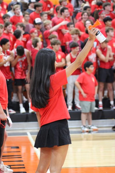 Senior Deetya Solanki blows the airhorn to signal the end of a competiton. Photo by Lauren Voigt.