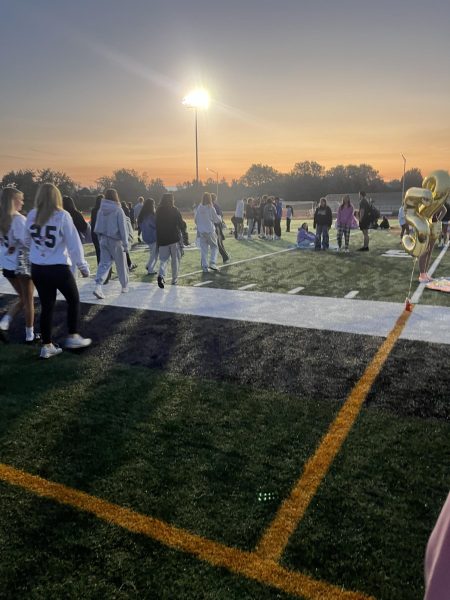 East seniors walk onto the football field for the annual senior sunrise. Photo by Brynn Copp