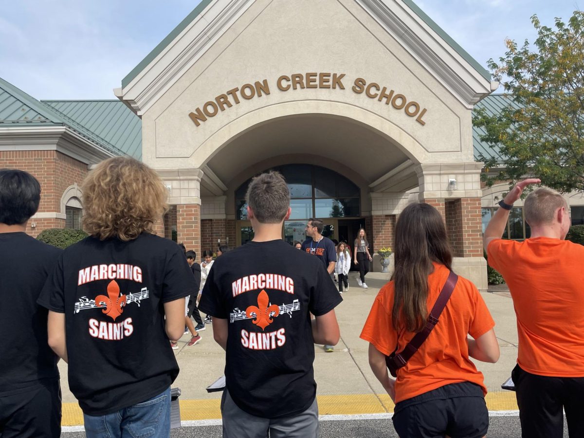 (Left to right) Zaac de Luna, Zack Poelsterl, Zach Powers, Ellinore Wifler and Joey Edgar stand in front of Norton Creek Elementary School. Photo by Yzabelle de Luna.