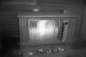 Creepy black and white picture with a dusty TV surrounded garbage all around it. Photo courtesy of Flickr.