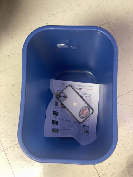 A phone inside the recycling bin. Photo by Aundrea Woods.