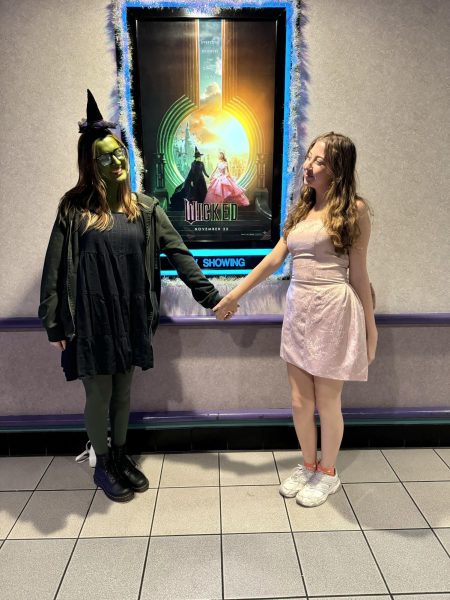 East senior Molly Burch (left) and Kaneland senior Natalie Foss-Ortega (right) dressed up at the opening night of “Wicked.” Photo by Molly Burch.