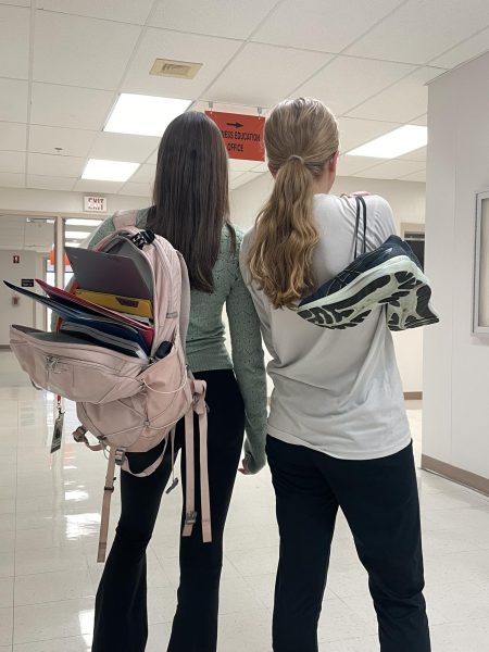 Two student athletes pose in the halls of St. Charles East. Photo by Lauren Voigt.