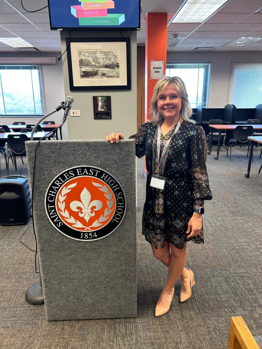 St. Charles' incumbent mayor Lora Vitek poses next to a St. Charles East podium in the LRC. Photo by Arjun Patel.