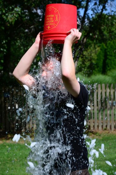 A person pours a bucket of ice-cold water on themselves to raise awareness about mental health. Photo courtesy of Flickr.