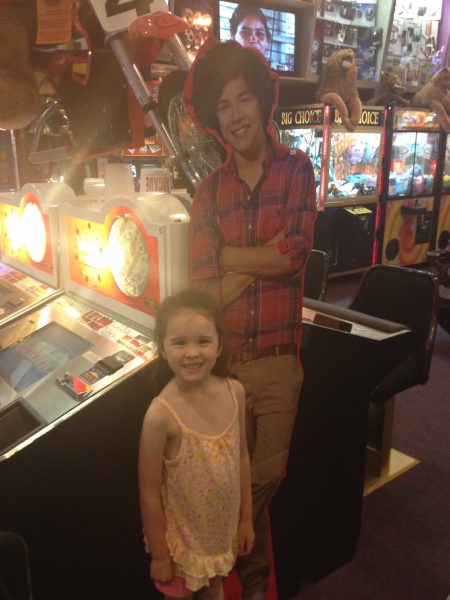 Senior Aundrea Woods stands with a cardboard cutout of her idol Harry Styles at six years old. Photo by Laruren Garbutt.