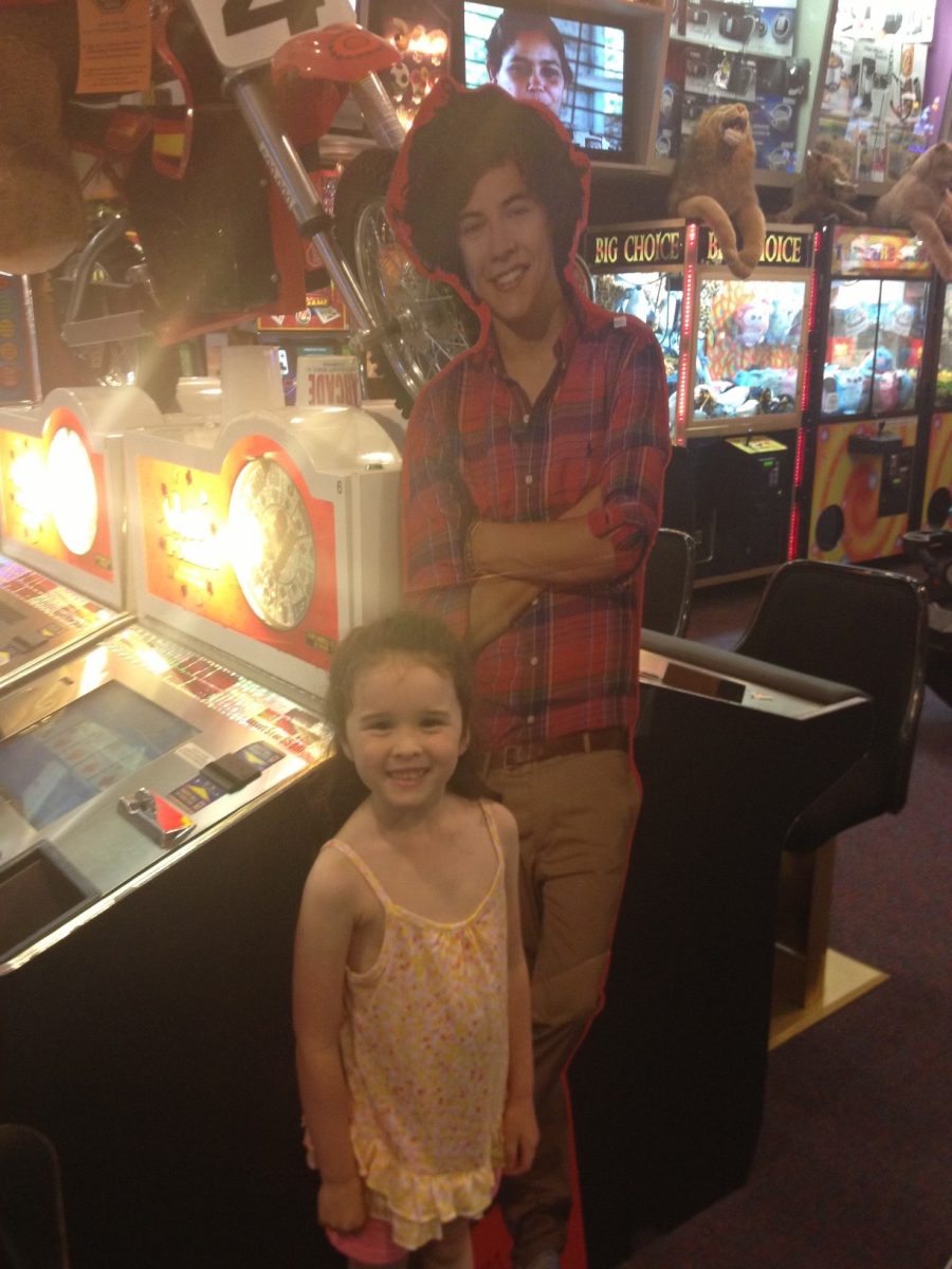 Senior Aundrea Woods stands with a cardboard cutout of her idol Harry Styles at six years old. Photo by Laruren Garbutt.