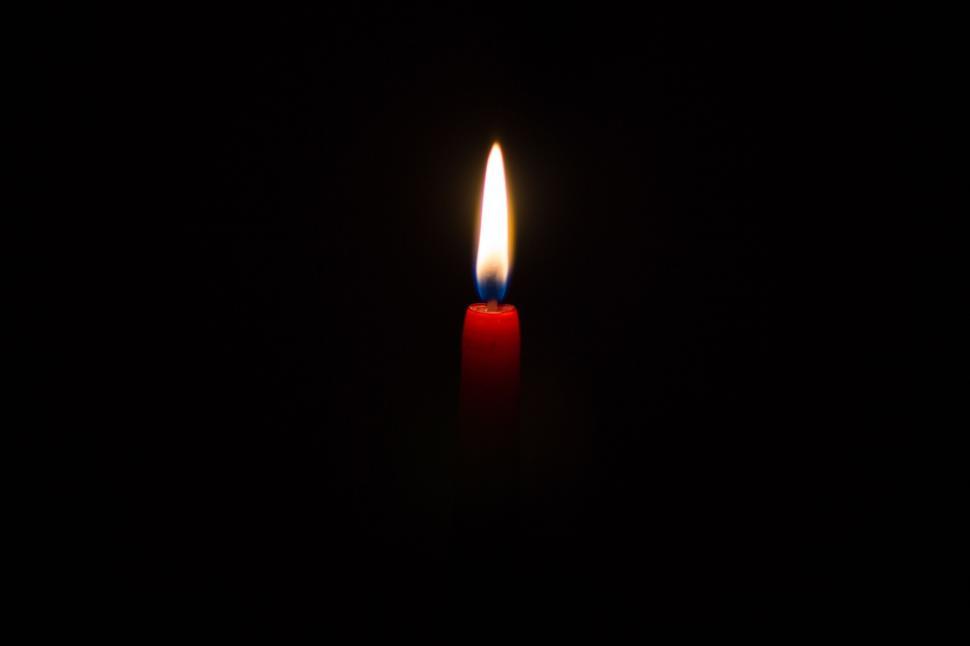 A single candle illuminated in darkness. Photo courtesy of Freerange stock.