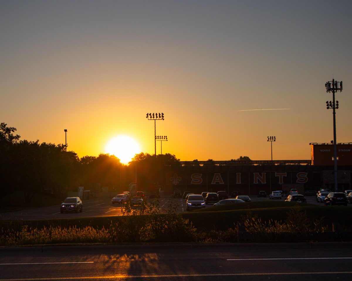 The sun rising during senior sunrise. 